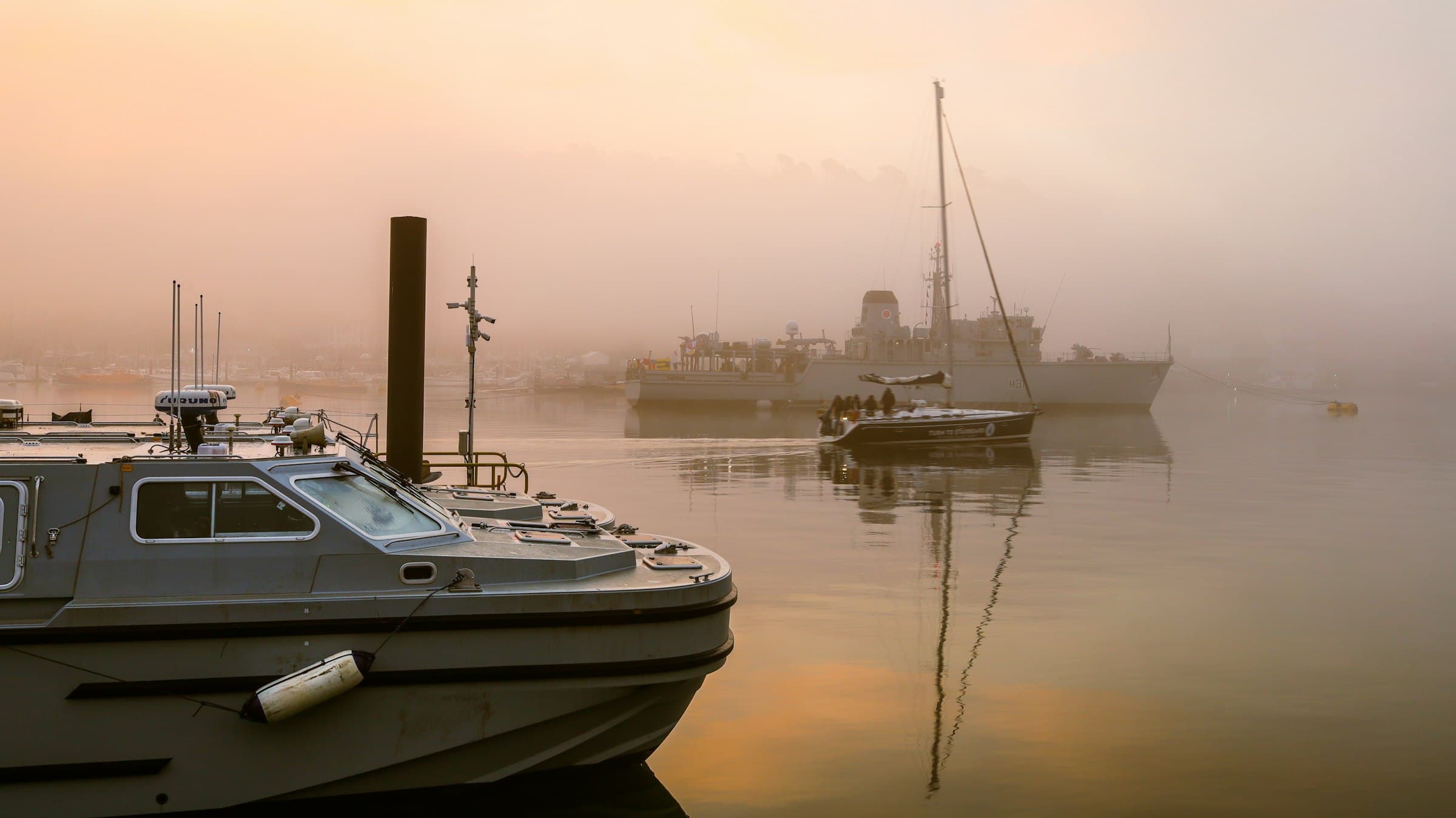 A calm, misty harbor at first light